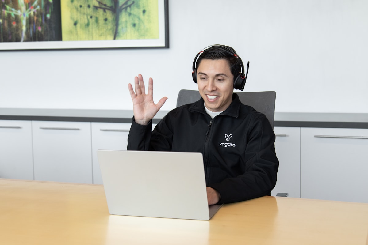 IT support professional working with a headset and laptop